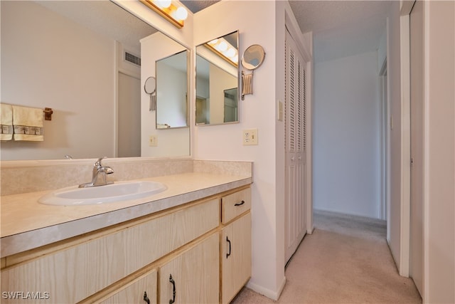 bathroom with a textured ceiling and vanity