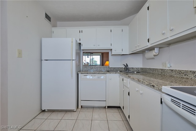 kitchen featuring light stone counters, light tile patterned floors, sink, white appliances, and white cabinetry