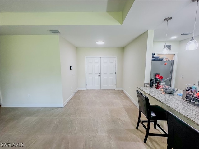 interior space with light hardwood / wood-style floors and bar