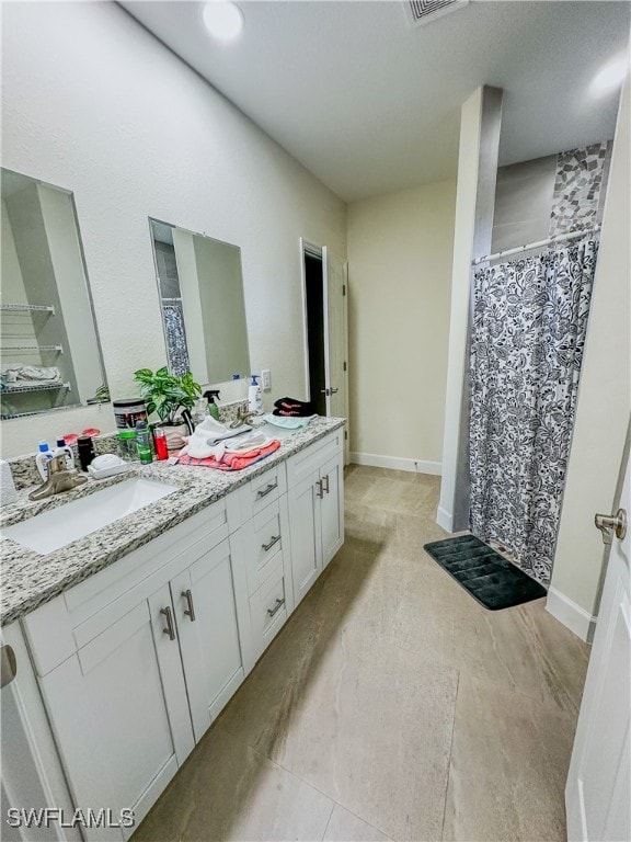 bathroom featuring vanity and curtained shower