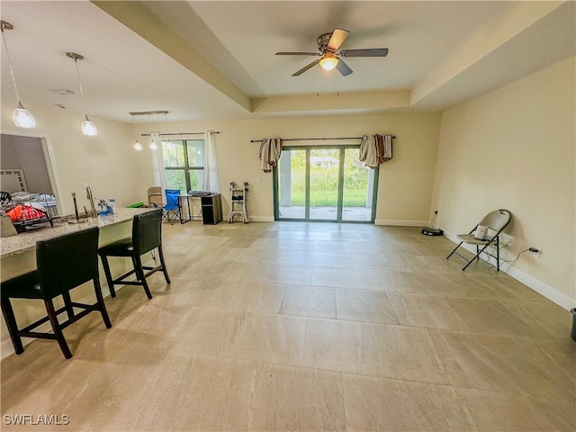 interior space with a tray ceiling and ceiling fan