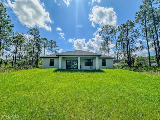 back of property with a lawn