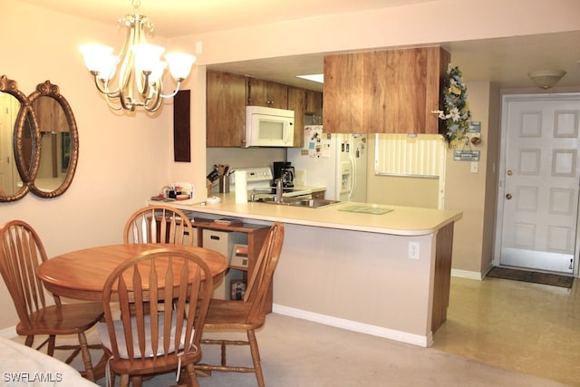 kitchen featuring white appliances, kitchen peninsula, decorative light fixtures, sink, and a notable chandelier