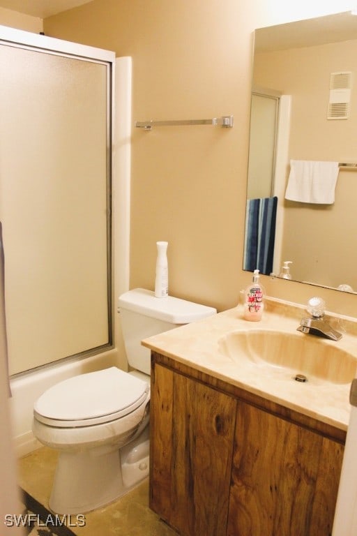 full bathroom featuring shower / bath combination with glass door, vanity, and toilet