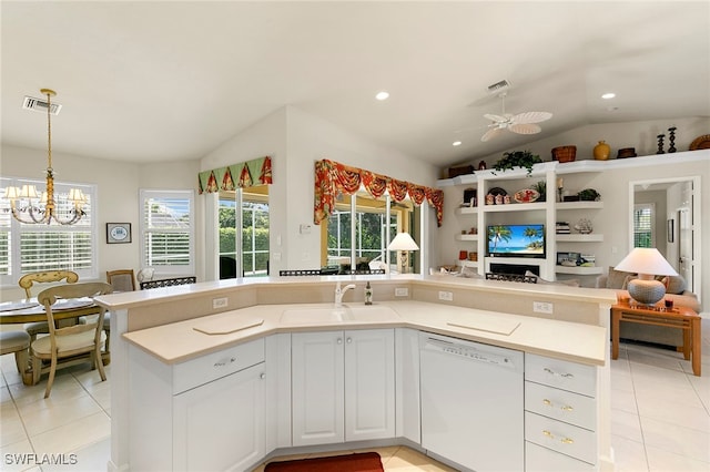 kitchen featuring lofted ceiling, sink, white cabinetry, dishwasher, and ceiling fan with notable chandelier