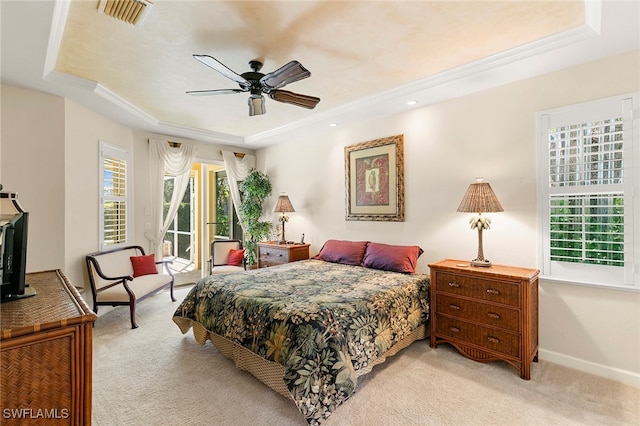 bedroom featuring access to exterior, a tray ceiling, ceiling fan, ornamental molding, and light carpet