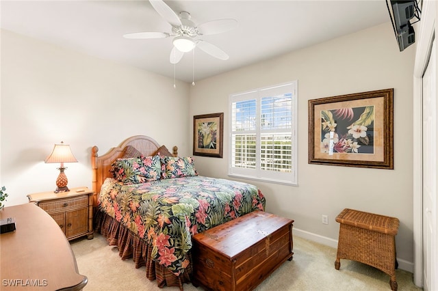 carpeted bedroom with ceiling fan and a closet