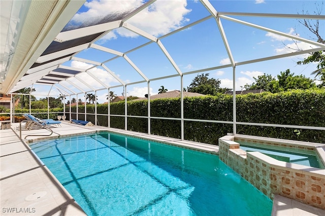 view of pool with a patio, an in ground hot tub, and a lanai