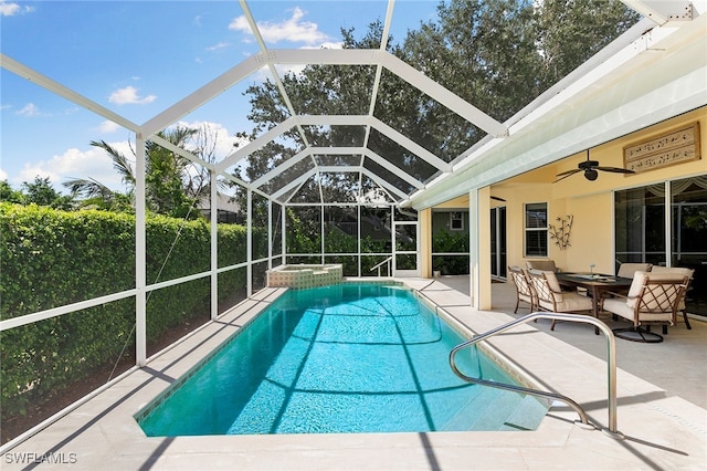 view of pool with ceiling fan, glass enclosure, a patio, and an in ground hot tub