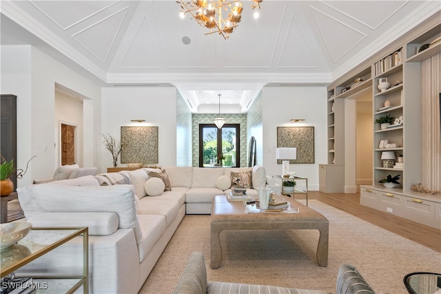 living room with ornamental molding, light wood-type flooring, a chandelier, and built in features