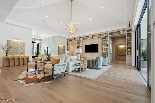 living room with ornamental molding, a chandelier, and light hardwood / wood-style floors