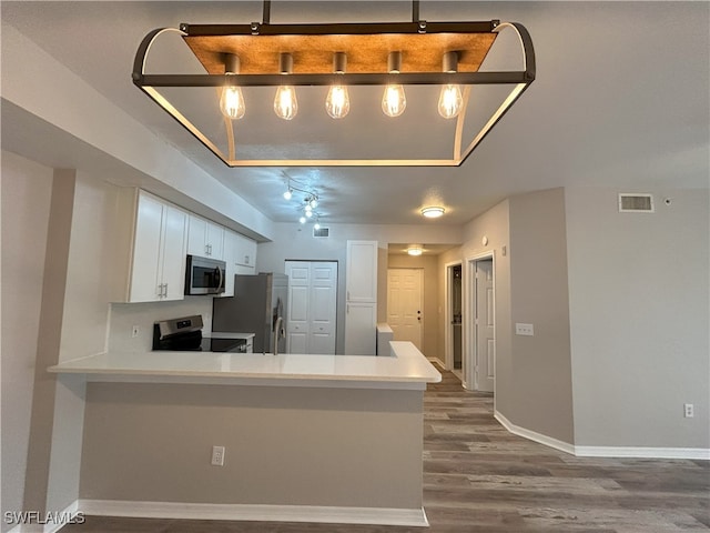 kitchen featuring light wood-type flooring, kitchen peninsula, stainless steel appliances, and white cabinetry