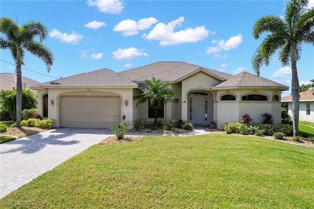 mediterranean / spanish-style house featuring a garage and a front yard