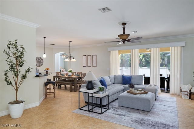 tiled living room featuring ornamental molding and ceiling fan with notable chandelier