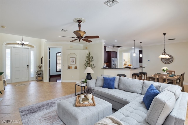 tiled living room featuring a wealth of natural light, crown molding, and ceiling fan with notable chandelier