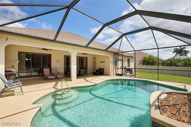 view of pool featuring a lanai, a patio area, and ceiling fan