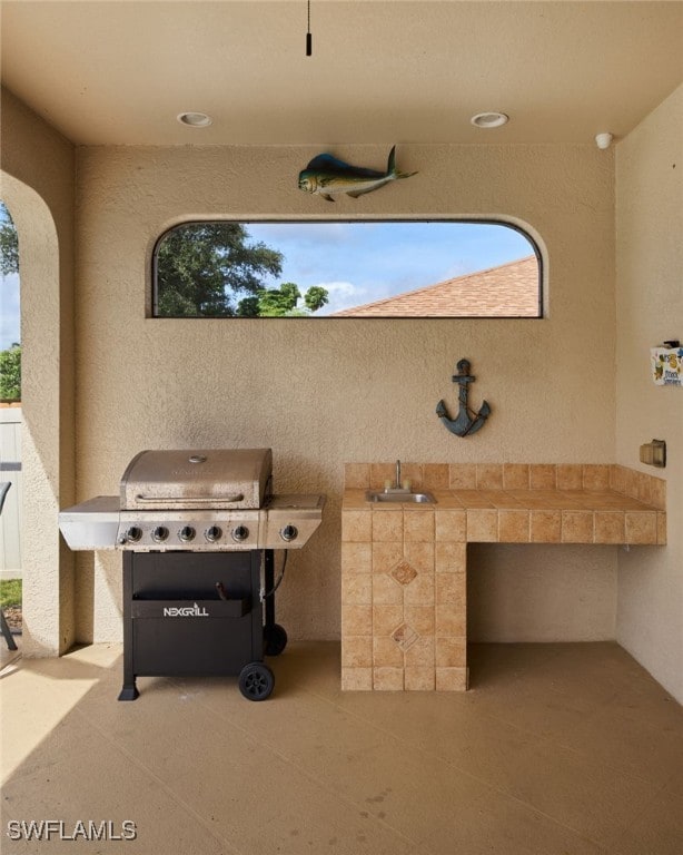 view of patio / terrace featuring a grill and sink