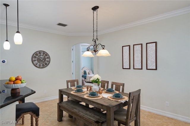 tiled dining space featuring ornamental molding