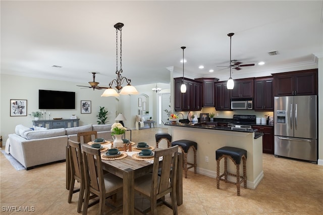 dining area with ceiling fan, light tile patterned flooring, and ornamental molding