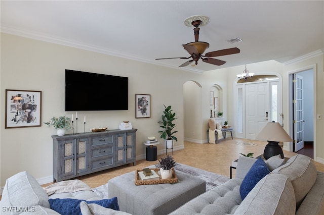 tiled living room with ceiling fan with notable chandelier and crown molding