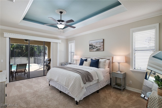 bedroom featuring ornamental molding, access to outside, ceiling fan, carpet, and a tray ceiling