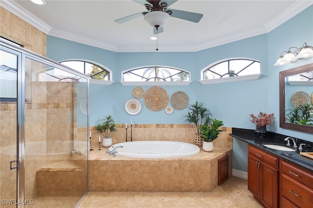 bathroom with tile patterned floors, a healthy amount of sunlight, shower with separate bathtub, and vanity