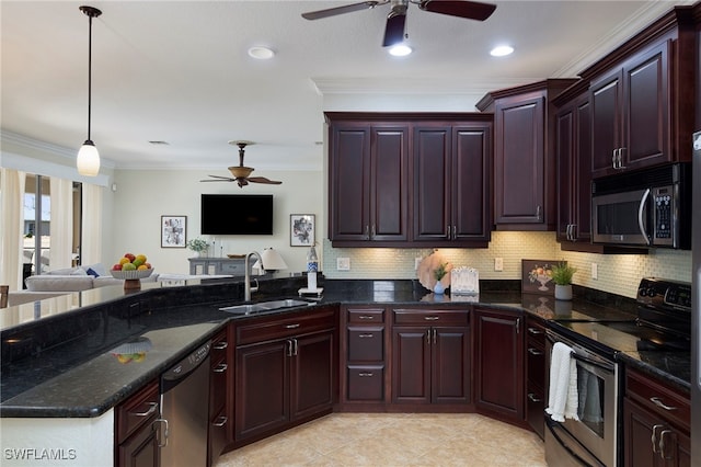 kitchen featuring pendant lighting, stainless steel appliances, sink, ceiling fan, and dark stone counters