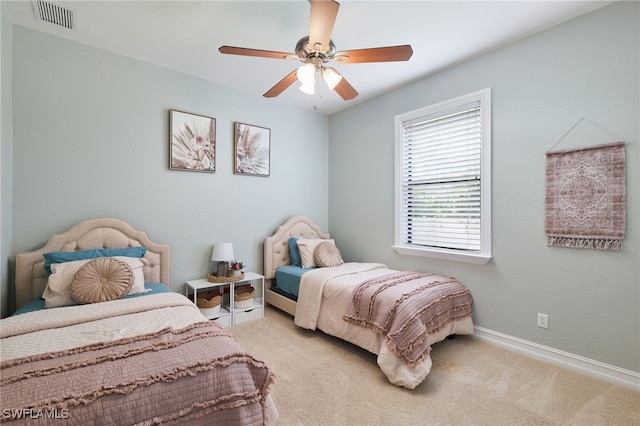 bedroom featuring ceiling fan and light carpet