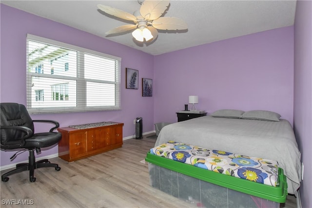 bedroom featuring light wood-type flooring and ceiling fan