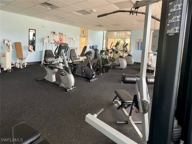 workout area with a paneled ceiling