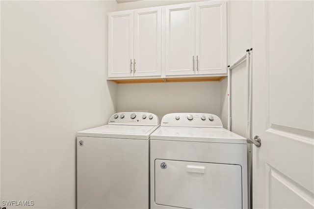 laundry room featuring cabinets and separate washer and dryer