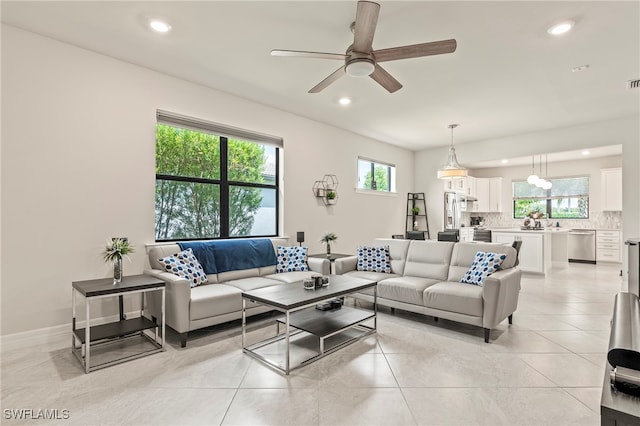 living room with ceiling fan and light tile patterned floors