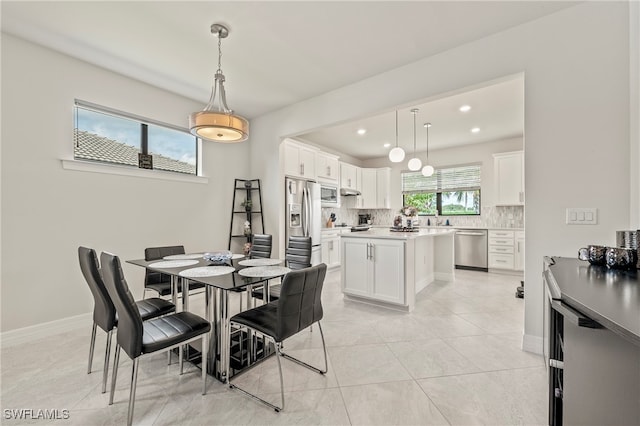 dining area featuring light tile patterned flooring