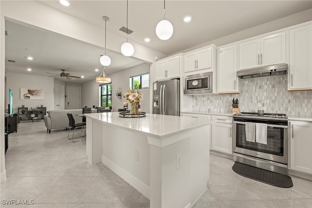 kitchen featuring white cabinets, a kitchen island, appliances with stainless steel finishes, decorative light fixtures, and ceiling fan