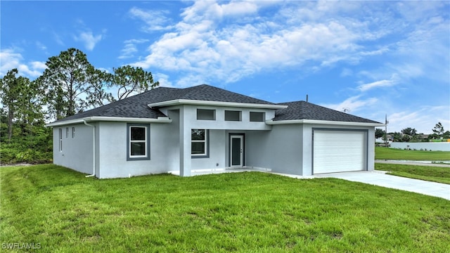 view of front of property featuring a garage and a front yard