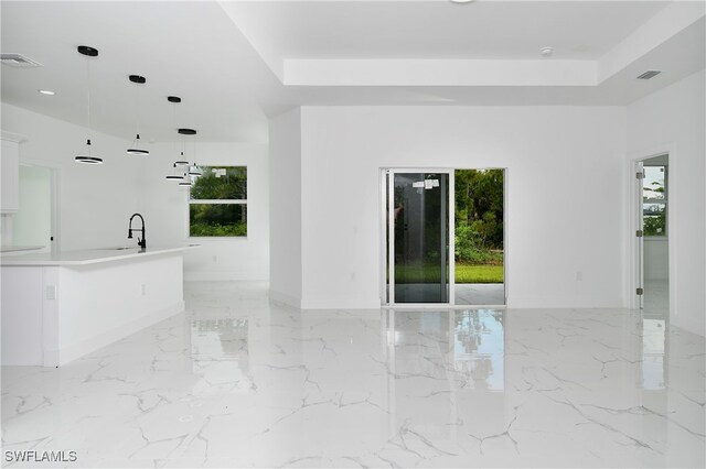 unfurnished living room featuring sink