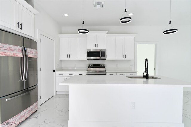 kitchen with pendant lighting, stainless steel appliances, white cabinetry, and sink