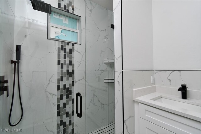 bathroom featuring vanity, tile walls, and a shower with shower door