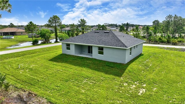 view of side of home with a yard