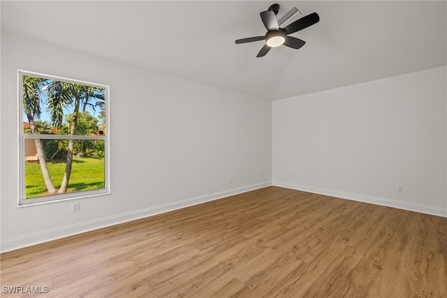 unfurnished room featuring lofted ceiling, plenty of natural light, ceiling fan, and light hardwood / wood-style flooring