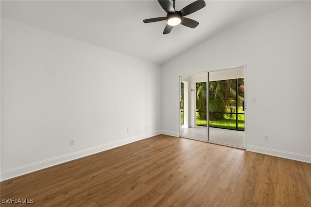 spare room featuring ceiling fan, wood-type flooring, and vaulted ceiling