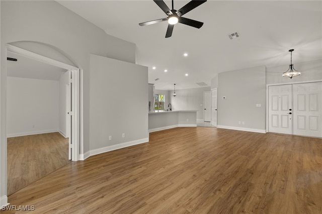 unfurnished living room featuring ceiling fan and light hardwood / wood-style floors