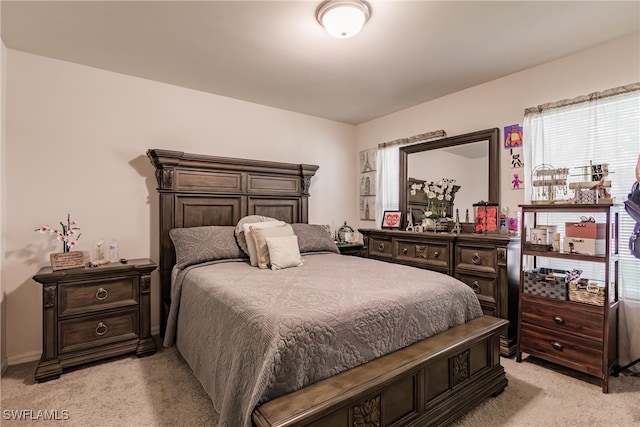 carpeted bedroom featuring multiple windows