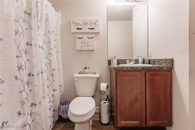 bathroom featuring vanity, toilet, hardwood / wood-style floors, and walk in shower