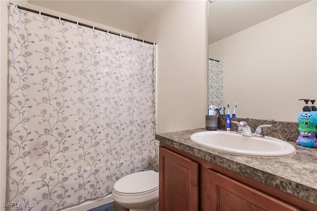 bathroom featuring a shower with shower curtain, toilet, and vanity