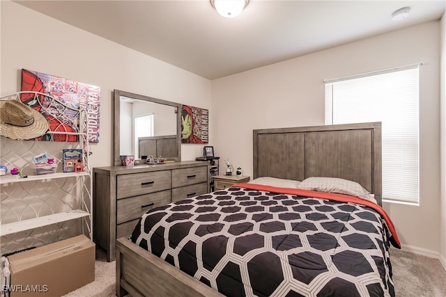 bedroom with light carpet and multiple windows