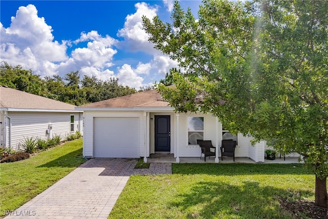 view of front of house with a garage and a front yard