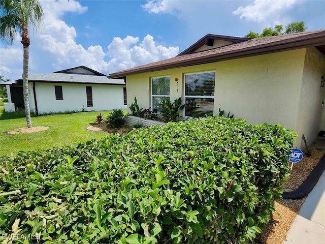 view of home's exterior with a lawn