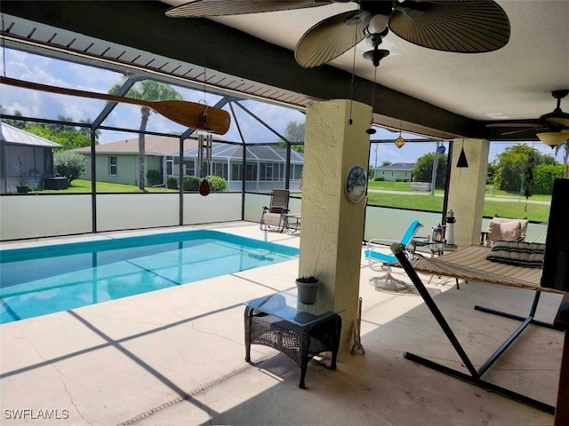 view of swimming pool featuring a lanai and a patio