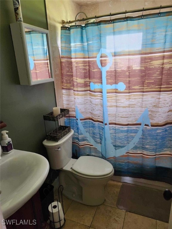 bathroom with sink, a shower with curtain, toilet, and tile patterned flooring